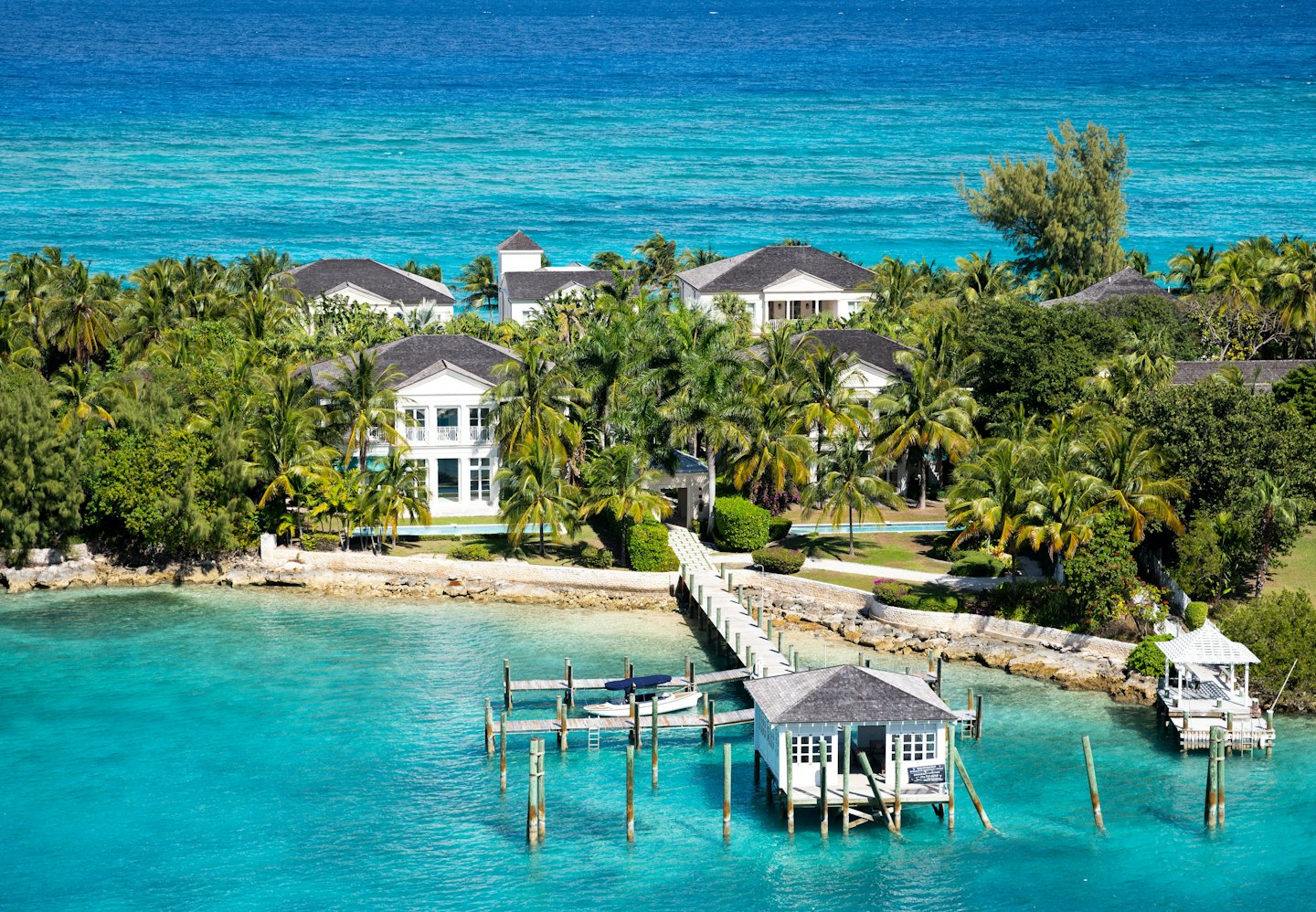 Luxury waterfront villas with docks on a tropical island.